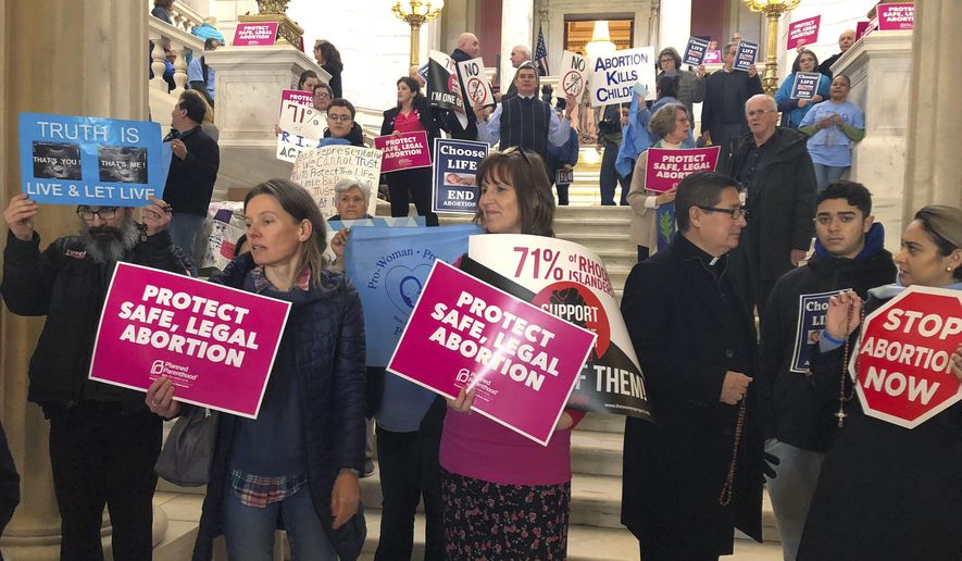 People both supporting and opposing abortion protest at the Statehouse, Tuesday, March 5, 2019, in Providence, R.I., where a house committee is set to vote whether to enshrine abortion protections in state law, joining states around the country that are revisiting their laws in anticipation of renewed federal fights over abortion. (AP Photo/Jennifer McDermott) ** FILE **