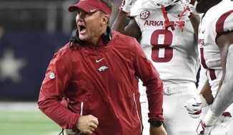 FILE - In this Sept. 29, 2018, file photo, Arkansas head coach Chad Morris celebrates with his players after a missed field goal by Texas A&amp;amp;M during the fourth quarter of an NCAA college football game, in Arlington, Texas. After a 2-10 season, Arkansas has opened spring practice with a mantra that is as much physical as it is metaphorical: “Earn everything.” Coach Chad Morris will go into his second year with the Razorbacks insisting that every member of the team from the quarterback to the equipment staff gives their best. (AP Photo/Jeffrey McWhorter, File)