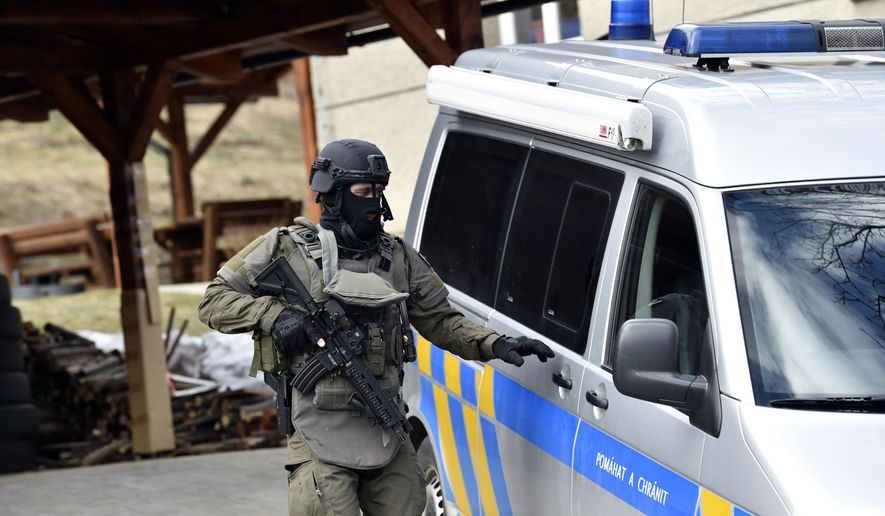 CAPTION CORRECTS THE AGE - A special force policeman at the scene where a male lion attacked and killed a 33-year-old breeder in Zdechov village near Vsetin, Czech Republic, Tuesday, March 5, 2019. Police say a man was mauled to death by his pet lion in a village in eastern Czech Republic. When police arrived, they found two lions in an enclosure with a body of a man. After they assessed the situation with experts from a nearby zoo, they shot dead the animals. (Dalibor Gluck/CTK via AP)
