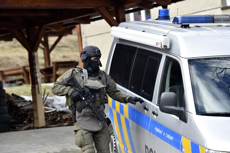 CAPTION CORRECTS THE AGE - A special force policeman at the scene where a male lion attacked and killed a 33-year-old breeder in Zdechov village near Vsetin, Czech Republic, Tuesday, March 5, 2019. Police say a man was mauled to death by his pet lion in a village in eastern Czech Republic. When police arrived, they found two lions in an enclosure with a body of a man. After they assessed the situation with experts from a nearby zoo, they shot dead the animals. (Dalibor Gluck/CTK via AP)