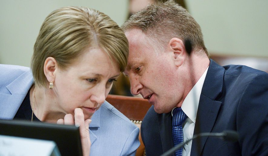 Rep. Craig Hall, R-West Valley City confers with Judiciary chair Rep. Karianne Lisonbee, during the House Judiciary Committee meeting in Salt Lake City, Utah, on Tuesday, March 5, 2019. Hall watched lawmakers dismantle his bill to end conversion therapy and replace it with an alternative that he says would do nothing to stop the widely-discredited practice. (Leah Hogsten/The Salt Lake Tribune via AP)