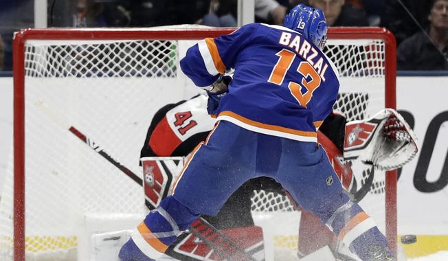 New York Islanders center Mathew Barzal (13) scores on Ottawa Senators goaltender Craig Anderson (41) in the shootout of an NHL hockey game, Tuesday, March 5, 2019, in Uniondale, N.Y. The Islanders won 5-4. (AP Photo/Kathy Willens)