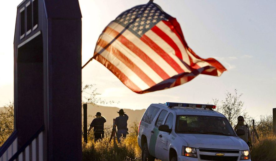 U.S. Border Patrol agents and vehicle are seen in this undated file photo. (Associated Press) ** FILE **