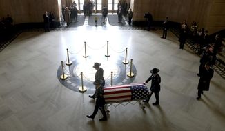The casket of Oregon&#x27;s Secretary of State Dennis Richardson is brought into the rotunda at the Oregon State Capitol in Salem, Ore., on Wednesday, March 6, 2019. (Anna Reed/Statesman-Journal via AP)