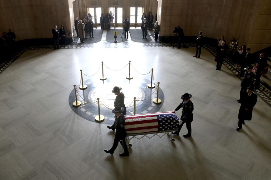The casket of Oregon's Secretary of State Dennis Richardson is brought into the rotunda at the Oregon State Capitol in Salem, Ore., on Wednesday, March 6, 2019. (Anna Reed/Statesman-Journal via AP)