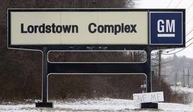 A &amp;quot;Save Me&amp;quot; sign rests against the Lordstown Complex sign, Wednesday, March 6, 2019, in Lordstown, Ohio. General Motors&#x27; sprawling Lordstown assembly plant near Youngstown is about to end production of the Chevrolet Cruze sedan, ending for now more than 50 years of auto manufacturing at the site. (AP Photo/Tony Dejak)