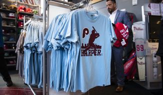 A customer shops for Philadelphia Phillies&#x27; Bryce Harper baseball apparel at Citizens Bank Park in Philadelphia, Monday, March 4, 2019. (AP Photo/Matt Rourke)
