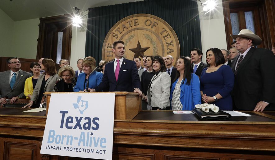 State Rep. Jeff Leach, at podium, stands with fellow lawmakers and guests to talk about the Texas Born-Alive bill, Thursday, March 7, 2019, in Austin, Texas. (AP Photo/Eric Gay)