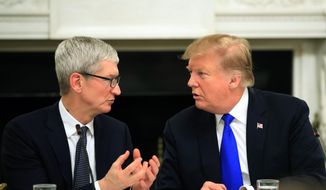 In this Wednesday, March 6, 2019 file photo, President Donald Trump talks to Apple Inc. CEO Tim Cook during the American Workforce Policy Advisory Board&#39;s first meeting in the State Dining Room of the White House in Washington. (AP Photo/Manuel Balce Ceneta, File)