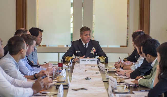 CORRECTS LOCATION TO SINGAPORE - Adm. Phil Davidson, center, the head of the U.S. Indo-Pacific Command, speaks with the media in Singapore Thursday, March 7, 2019. Davidson told reporters Thursday that he is working with countries including South Korea, Japan, Australia, New Zealand, Canada and France, to enforce sanctions against North Korea at sea. (Mass Communication 1st Specialist Robin W. Peak/U.S. Navy via AP)