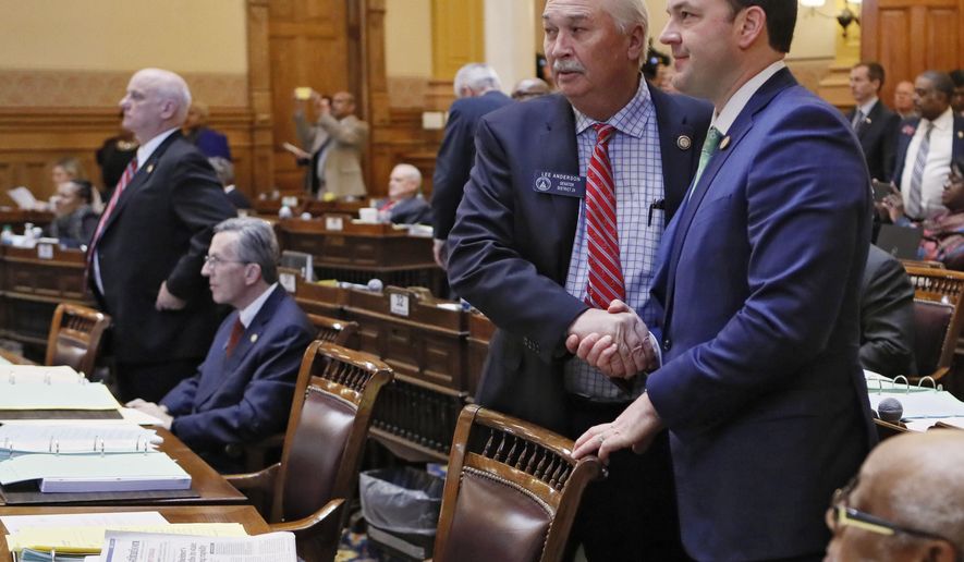 State Sen. Burt Jones, sponsor of the bill to give the state control of Hartsfield-Jackson airport, is congratulated by Senator Lee Anderson, R - Grovetown, after the passage of the bill Thursday, March 7, 2019. The Georgia Senate voted Thursday to approve a measure that would give the state control of Hartsfield-Jackson airport. The legislature was in session for "crossover" day, the 28th day of the 2019 General Assembly. (Bob Andres/Atlanta Journal-Constitution via AP)