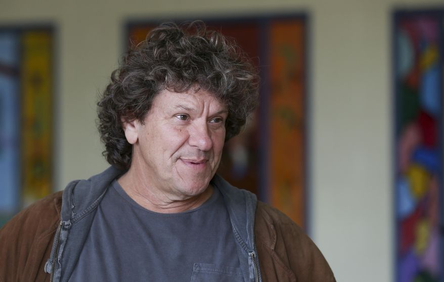 FILE - In this Wednesday, Oct. 14, 2015, file photo, Michael Lang speaks during a tour at the former Zena Elementary School in Woodstock, N.Y. Woodstock co-founder Michael Lang says the wait is almost over regarding performers for Woodstock 50, despite media reports claiming Jay-Z, Black Keys and others will perform at the event in August. The original Woodstock concert took place in 1969. On Thursday, March 7, 2019, Variety reported that Jay-Z, Black Keys, Dead & Company, Chance the Rapper, Imagine Dragons, the Killers, Gary Clark Jr. and others will perform at Woodstock 50.(AP Photo/Mike Groll, File)