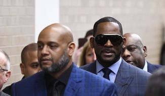 Musician R. Kelly arrives at the Daley Center for a hearing in his child support case at the Daley Center, Wednesday, March 6, 2019, in Chicago. Kelly was charged last month with sexually abusing four females dating back to 1998, including three underage girls. He&#x27;s pleaded not guilty.  (AP Photo/Matt Marton) **FILE**