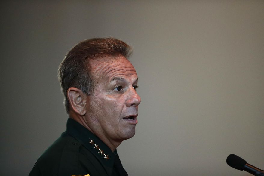 In this Thursday, Nov. 15, 2018, file photo, Broward County Sheriff Scott Israel speaks before the state commission in Sunrise, Fla. Israel, who was suspended by the governor and accused of failing to prevent the Parkland school shooting filed suit Thursday, March 7, 2019, seeking his job back and alleging Gov. Ron DeSantis improperly ousted him for political reasons. (AP Photo/Brynn Anderson, File)