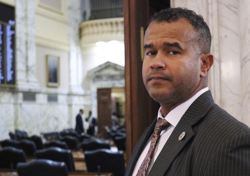 In this Feb. 28, 2019 photo, Del. C.T. Wilson stands outside the Maryland House of Delegates in Annapolis, Md. Wilson, a survivor of child sexual abuse who has spoken of his experience as he has advocated for laws to protect children, is sponsoring legislation in Maryland to prevent teachers with records of sexual misconduct against students from moving from one school to another. Maryland has taken a step toward joining a growing number of states that have enacted legislation to prevent teachers with records of sexual misconduct from moving from school to school. The Maryland House of Delegates unanimously approved a bill Thursday, March 7, 2019 to ban nondisclosure agreements involving sexual abuse for school employees who have direct contact with children. (AP Photo/Brian Witte)