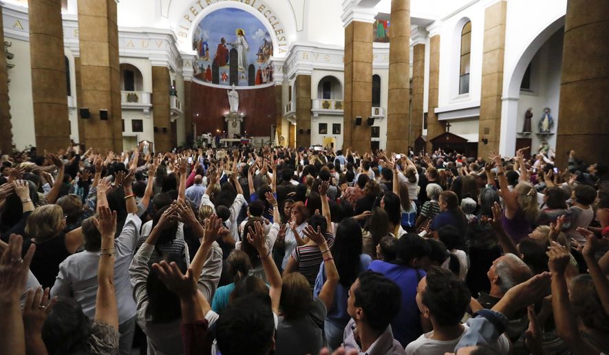 People greet Venezuelan Congress President Juan Guaido during the Ash Wednesday Mass celebrations in Caracas, Venezuela, Wednesday, March 6, 2019. The U.S. and more than 50 governments recognize Guaido as interim president, saying President Nicolas Maduro wasn't legitimately re-elected last year because opposition candidates weren't permitted to run. (AP Photo/Eduardo Verdugo)