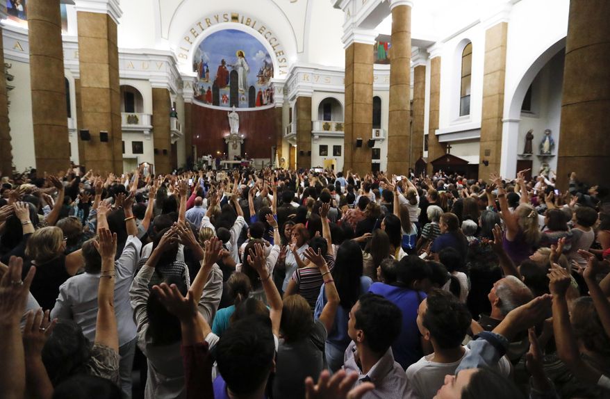 People greet Venezuelan Congress President Juan Guaido during the Ash Wednesday Mass celebrations in Caracas, Venezuela, Wednesday, March 6, 2019. The U.S. and more than 50 governments recognize Guaido as interim president, saying President Nicolas Maduro wasn't legitimately re-elected last year because opposition candidates weren't permitted to run. (AP Photo/Eduardo Verdugo)