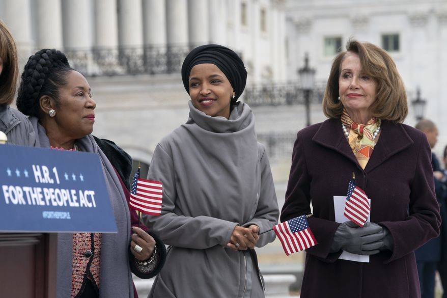 Rep. Ilhan Omar, D-Minn., smiles as she stands between Rep. Sheila Jackson Lee, D-Texas, left, and Speaker of the House Nancy Pelosi, D-Calif., as Democrats rally outside the Capitol ahead of passage of H.R. 1, &quot;The For the People Act,&quot; a bill which aims to expand voting rights and strengthen ethics rules, in Washington, Friday, March 8, 2019. (AP Photo/J. Scott Applewhite)