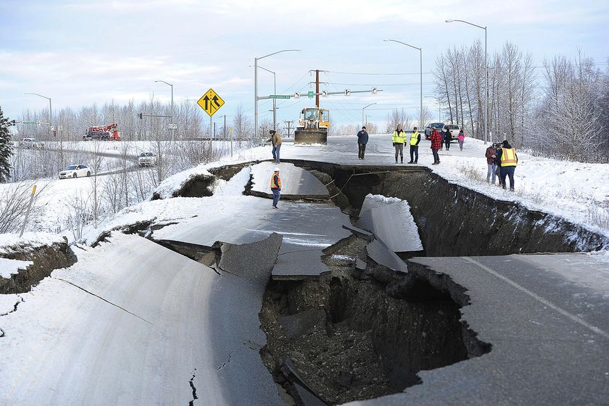 FILE - In this Nov. 30, 2018, file photo, workers inspect an off-ramp that collapsed during a morning earthquake in Anchorage, Alaska. Seismologists announced Friday, March 8, 2019, the magnitude of Alaska's powerful Nov. 30 earthquake has been revised to 7.1 from the earlier magnitude 7.0. Alaska Earthquake Center officials say in a release that the change comes after quake data was reviewed by multiple agency and academic groups. (AP Photo/Mike Dinneen, File)