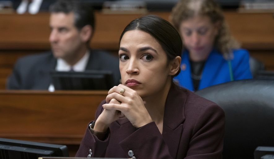 In this Feb. 27, 2019, photo, Rep. Alexandria Ocasio-Cortez, D-N.Y., listens to questioning of Michael Cohen on Capitol Hill in Washington. Ocasio-Cortez and several of her allies were accused this week by a conservative group of improperly masking political spending during the 2018 campaign. (AP Photo/J. Scott Applewhite) ** FILE **