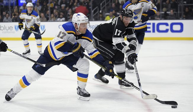St. Louis Blues left wing Jaden Schwartz, left, and Los Angeles Kings left wing Ilya Kovalchuk reach for the puck during the second period of an NHL hockey game Thursday, March 7, 2019, in Los Angeles. (AP Photo/Mark J. Terrill)