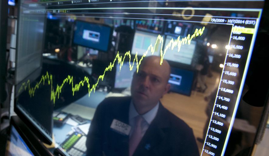 FILE - In this July 3, 2014, file photo, specialist Jay Woods is reflected in a screen at his post that shows five years of the Dow Jones industrial average, on the floor of the New York Stock Exchange. The biggest change over the last 10 years, many professional investors say is that index funds have become the default way for many to invest. (AP Photo/Richard Drew, File)