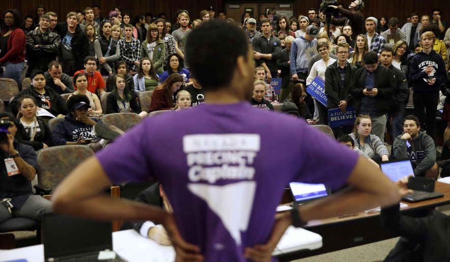 FILE - In this Feb. 20, 2016 file photo a precinct captain argues his position during a Democratic caucus at the University of Nevada in Reno, Nev. Nevada Democrats are proposing major changes to their presidential caucuses that could dramatically alter the way candidates compete in the state, opening the process to an early-vote and virtual participation. (AP Photo/Marcio Jose Sanchez,File)