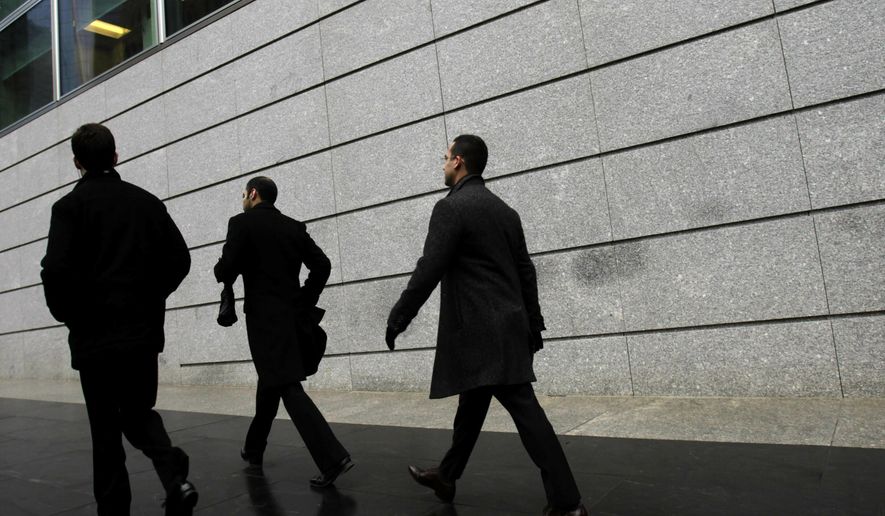 In this Jan. 17, 2012, file photo, pedestrians walk past the front of Goldman Sachs headquarters in New York. Business casual has become such an entrenched trend that even Goldman Sachs surrendered to it with a memo to employees announcing flexible dress code. (AP Photo/Seth Wenig, File)