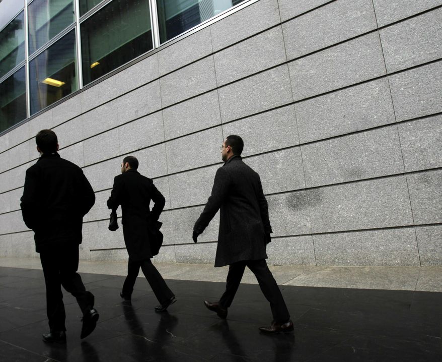 In this Jan. 17, 2012, file photo, pedestrians walk past the front of Goldman Sachs headquarters in New York. Business casual has become such an entrenched trend that even Goldman Sachs surrendered to it with a memo to employees announcing flexible dress code. (AP Photo/Seth Wenig, File)