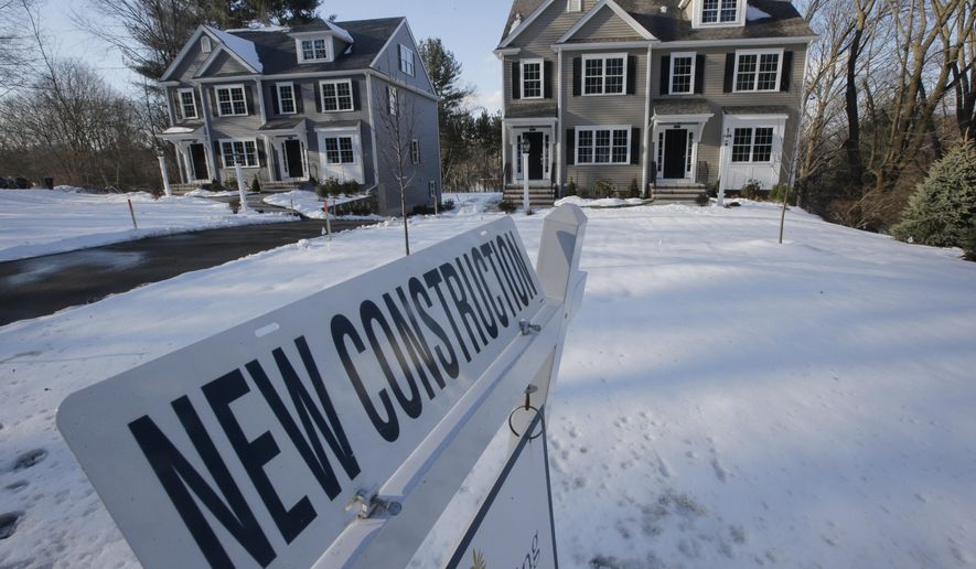 In this Thursday, Feb. 21, 2019 photo a newly constructed homes sit near a sign, in Natick, Mass. On Friday, March 8, the Commerce Department reports on U.S. home construction in January.(AP Photo/Steven Senne)