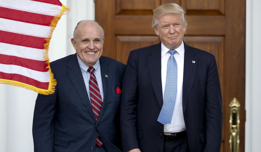FILE - In this Nov. 20, 2016, file photo, then-President-elect Donald Trump, right, and former New York Mayor Rudy Giuliani pose for photographs as Giuliani arrives at the Trump National Golf Club Bedminster clubhouse in Bedminster, N.J.. (AP Photo/Carolyn Kaster, File) **FILE**