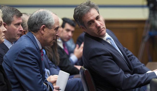 Michael Cohen, right, President Donald Trump&#x27;s former lawyer, leans back to listen to his lawyer, Lanny Davis of Washington, as he testifies before the House Oversight and Reform Committee, on Capitol Hill, Wednesday in Washington. (AP Photo/Alex Brandon)