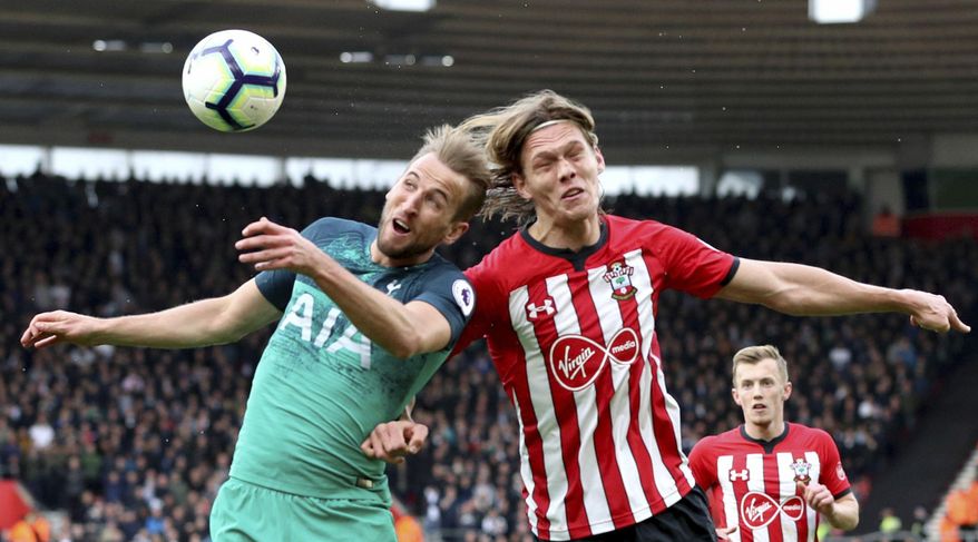 Tottenham Hotspur's Harry Kane, left, and Southampton's Jannik Vestergaard battle for the ball during the English Premier League soccer match at St Mary's Stadium, Southampton, England, Saturday March 9, 2019. (Andrew Matthews/PA via AP)