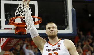 Virginia center Jack Salt (33) holds the net after a victory over Louisville after an NCAA college basketball game in Charlottesville, Va., Saturday, March 9, 2019. (AP Photo/Steve Helber) ** FILE **