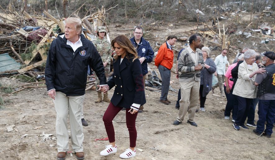 In this March 8, 2019, phot, President Donald Trump and first lady Melania Trump walk hand in hand in Beauregard, Ala., as they tour areas where tornados killed 23 people in Lee County, Ala. Melania Trump largely avoided the campaign trail in 2016, limiting her role to a handful of appearances and interviews. But as President Donald Trump shows his eagerness for the coming 2020 re-election battle, less clear is the first lady’s fervor for participating in the effort. (AP Photo/Carolyn Kaster)