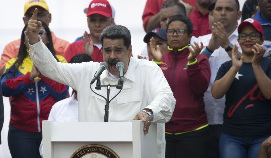 Venezuela&#39;s President Nicolas Maduro speaks to supporters during a government rally in Caracas, Venezuela, Saturday, March 9, 2019.  Demonstrators danced and waved flags on what organizers labeled a “day of anti-imperialism” in a show of defiance toward the United States, which has imposed oil sanctions on Venezuela in an attempt to oust the president. (AP Photo/Ariana Cubillos)