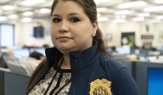 In this Feb. 11, 2019 photo, Rebecca Shutt, who works in the New York Police Department&#x27;s Office of Crime Control Strategies, poses for a photo in New York. Shutt utilizes a software called Patternizr, which allows crime analysts to compare robbery, larceny and theft incidents to the millions of crimes logged in the NYPD&#x27;s database, aiding their hunt for crime patterns. It&#x27;s much faster than the old method, which involved analysts sifting through reports and racking their brains for similar incidents. (AP Photo/Mark Lennihan)