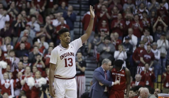 Indiana forward Juwan Morgan (13) waves to the fans after being taken out of the second half of an NCAA college basketball game against Rutgers, Sunday, March 10, 2019, in Bloomington, Ind. (AP Photo/Darron Cummings)