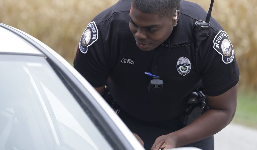 A police officer makes a traffic stop in Whitestown, Ind. (AP Photo/Darron Cummings)