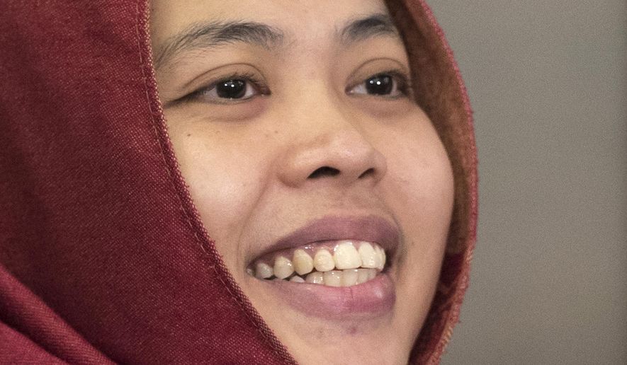 Indonesian Siti Aisyah smiles after a press conference at Indonesian Embassy in Kuala Lumpur, Malaysia, Monday, March 11, 2019. The Indonesian woman held two years on suspicion of killing North Korean leader's half brother Kim Jong Nam was freed from custody Monday after prosecutors unexpectedly dropped the murder charge against her. (AP Photo/Vincent Thian)