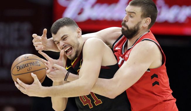 Toronto Raptors&#x27; Marc Gasol, right, from Spain, battles with Cleveland Cavaliers&#x27; Ante Zizic (41), from Croatia, for the ball in the second half of an NBA basketball game, Monday, March 11, 2019, in Cleveland. Gasol was called for a foul. The Cavaliers won 126-101. (AP Photo/Tony Dejak)