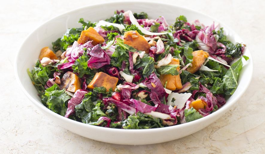 This undated photo provided by America's Test Kitchen in March 2019 shows Kale Salad With Sweet Potatoes. The recipe appears in the cookbook "The Complete Mediterranean Cookbook." (Carl Tremblay/America's Test Kitchen via AP)