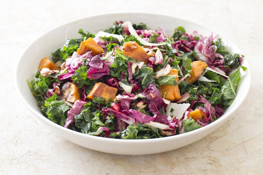 This undated photo provided by America's Test Kitchen in March 2019 shows Kale Salad With Sweet Potatoes. The recipe appears in the cookbook "The Complete Mediterranean Cookbook." (Carl Tremblay/America's Test Kitchen via AP)