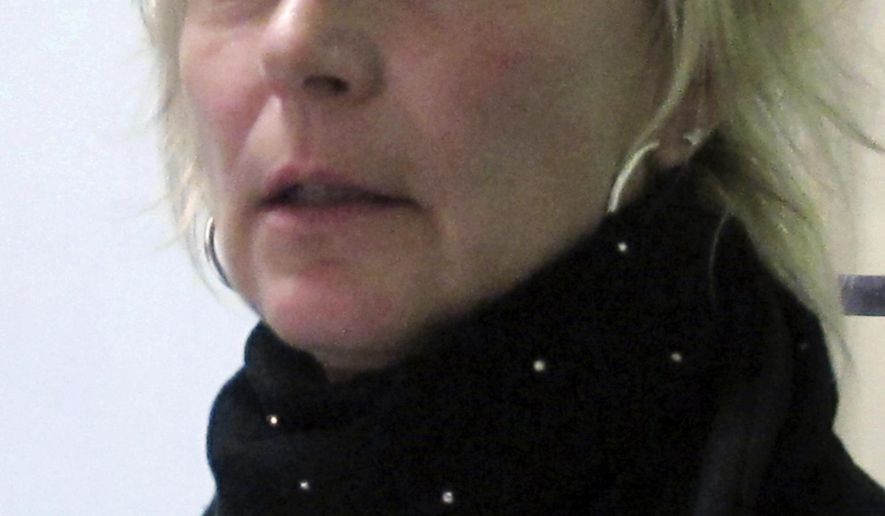 FILE - In this Dec. 28, 2012 file photo, former correctional officer Kristine Sink speaks during an interview with The Associated Press in Iowa City, Iowa. The former prison guard has reached a deal for $2.3 million as a settlement for discrimination and retaliation she says she suffered after filing a sexual harassment case against the state. The state paid Sink $1.65 million last month to settle the sexual harassment case, and the Iowa attorney general is recommending settling the second retaliation case. The State Appeal Board will decide Monday, March 11, 2019, whether to approve the settlement. (AP Photo/Ryan J. Foley, File)