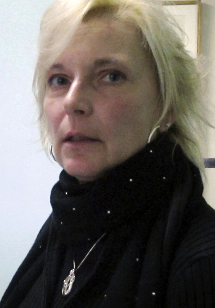 FILE - In this Dec. 28, 2012 file photo, former correctional officer Kristine Sink speaks during an interview with The Associated Press in Iowa City, Iowa. The former prison guard has reached a deal for $2.3 million as a settlement for discrimination and retaliation she says she suffered after filing a sexual harassment case against the state. The state paid Sink $1.65 million last month to settle the sexual harassment case, and the Iowa attorney general is recommending settling the second retaliation case. The State Appeal Board will decide Monday, March 11, 2019, whether to approve the settlement. (AP Photo/Ryan J. Foley, File)