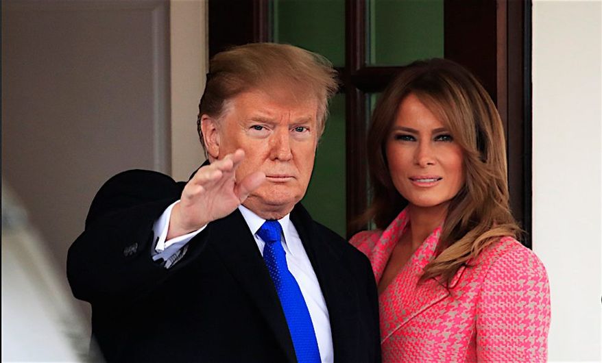 President Trump with first lady Melania Trump take a moment to wave, just outside the West Wing of the White House. (Associated Press)
