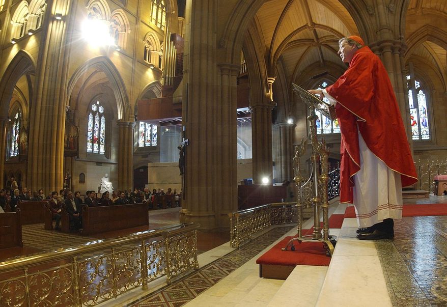 FILE - In this Sept. 14, 2004, file photo, Archbishop of Sydney, Cardinal George Pell, celebrates a special mass in Sydney's St. Mary's Cathedral. Pell was sentenced in an Australian court on Wednesday, March 13, 2019 to 6 years in prison for molesting two choirboys in a Melbourne cathedral more than 20 years ago. (AP Photo/Rick Rycroft, File)