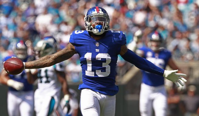 FILE - In this Oct. 7, 2018, file photo, New York Giants&#x27; Odell Beckham Jr. celebrates a catch against the Carolina Panthers during the first half of an NFL football game in Charlotte, N.C. Two people familiar with the blockbuster trade say the Cleveland Browns have agreed to acquire Beckham from the Giants. (AP Photo/Jason E. Miczek, File)