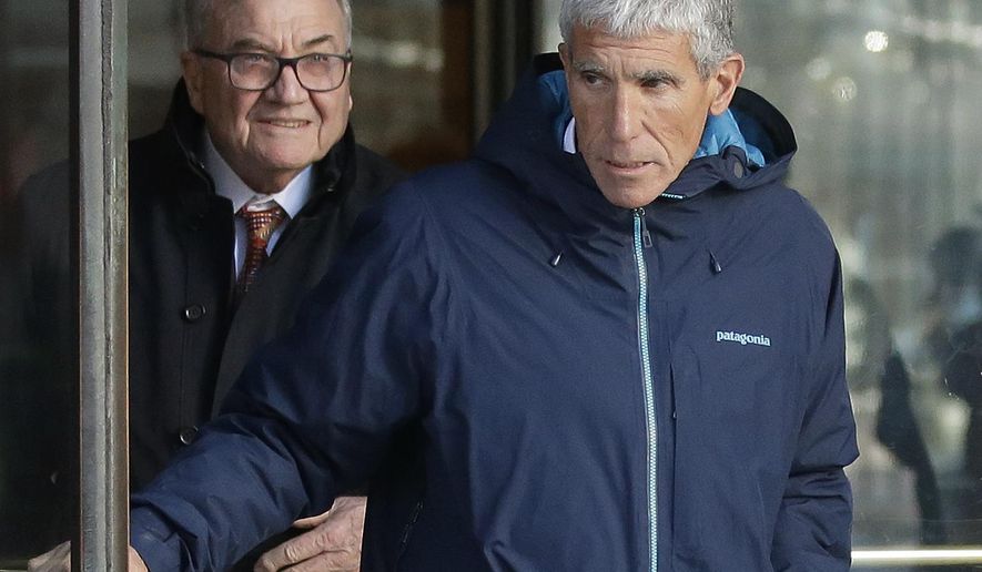 William "Rick" Singer, front, founder of the Edge College & Career Network, exits federal court in Boston on Tuesday, March 12, 2019, after he pleaded guilty to charges in a nationwide college admissions bribery scandal. (AP Photo/Steven Senne)