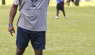 In a September 2016 photo, Yale&#39;s women&#39;s head soccer Coach Rudy Meredith gives pointers to players during a scrimmage in Ocala, Fla. According to the federal indictments unsealed Tuesday, March 12, 2019, former Yale soccer coach Rudy Meredith put a prospective student who didn’t play soccer on a school list of recruits, doctored her supporting portfolio to indicate she was a player, and later accepted $400,000 from the head of a college placement company.  (Doug Engle/Star-Banner via AP)